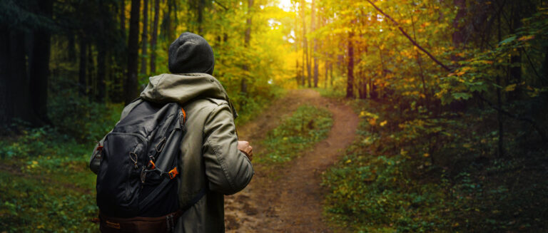 man hiking in the autumn forest.